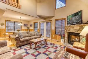 a living room with a couch and a fireplace at Brentwood, Resort Pool, FREE Attraction tickets, Near Parkway, Hot Tub, Arcade Game, WIFI!!! in Pigeon Forge