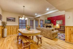 a living room with a table and a couch at Brentwood, Resort Pool, FREE Attraction tickets, Near Parkway, Hot Tub, Arcade Game, WIFI!!! in Pigeon Forge