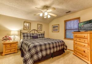 a bedroom with a bed and a ceiling fan at Brentwood, Resort Pool, FREE Attraction tickets, Near Parkway, Hot Tub, Arcade Game, WIFI!!! in Pigeon Forge +39 photos