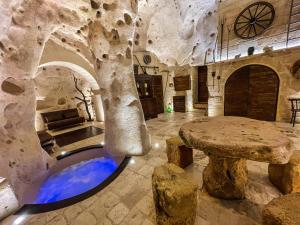 a room with a tree and a table in it at La Suite Nella Roccia in Matera