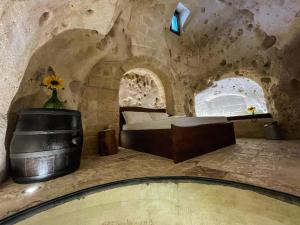 a bedroom with a bed in a stone room at La Suite Nella Roccia in Matera +70 photos