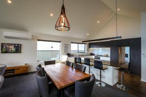 a kitchen and dining room with a wooden table and chairs at The Landsborough Tekapo in Lake Tekapo