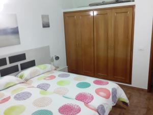 a bedroom with a bed and a wooden cabinet at Casa Teresa in El Paso +20 photos