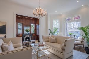 a living room with two couches and a chandelier at The George - Luxury Boutique Inn in Napa