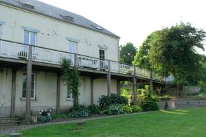 a white house with a balcony on the side of it at L'autre rive de la Tourelle in Ways