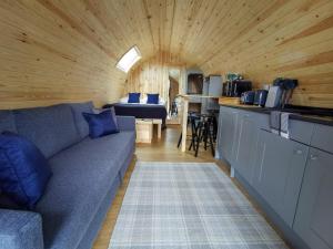 
a living room filled with furniture and a window at Highside Glamping Pods in Keswick
