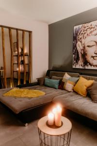 a living room with a couch and a table with candles at Monteurzimmer Pavan E2-KEINE Ferienwohnung in Saarlouis