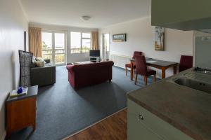 a kitchen and living room with a couch and a table at The Bay Motel in Half-moon Bay