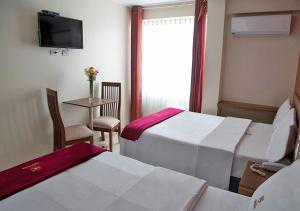 Postel nebo postele na pokoji v ubytování Hotel Central