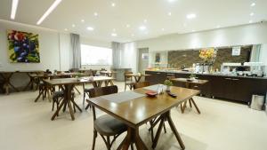 a restaurant with tables and chairs and a counter at Hotel Panorâmico in Carmo do Paranaíba