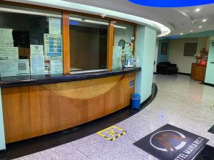 a restaurant with a counter in a building at HOTEL MARIA RICO in Mexico City