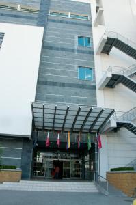 a building with flags hanging in front of it at Hotel San Silvestre in Barrancabermeja