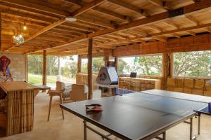 a room with a ping pong table in a house at Casa Bosque de Niebla in Guasca