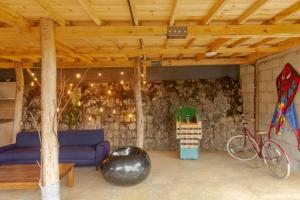 a living room with a blue couch in a stone wall at Casa Bosque de Niebla in Guasca