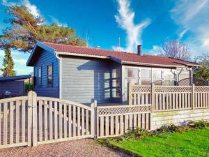 a house with a wooden fence in front of it at 4 person holiday home in Svendborg in Svendborg