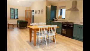 kuchnia ze stołem i krzesłami w pokoju w obiekcie Lavender Cottage - 2 Bedroom Home w mieście Newbridge