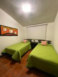 En eller flere senger på et rom på Casa Guelaguetza By Rotamundos