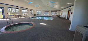 a large room with a swimming pool in a building at Best Western Executive Inn & Suites in Madisonville
