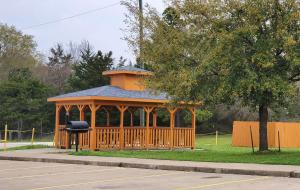a wooden gazebo in a park with a tree at Best Western Executive Inn & Suites in Madisonville
