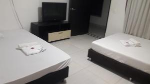 Postel nebo postele na pokoji v ubytování montecarlos hotel