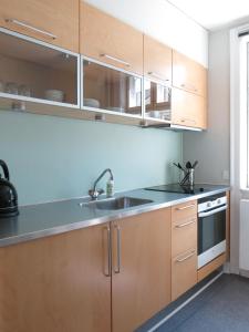 コペンハーゲンにあるApartmentInCopenhagen Apartment 1142のキッチン(木製キャビネット、シンク付)