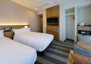 Postel nebo postele na pokoji v ubytování Far East Village Hotel Yokohama