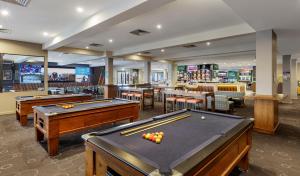 a billiard room with pool tables and a bar at Dorset Gardens Hotel in Croydon