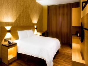 Postel nebo postele na pokoji v ubytování Yu Chun Hotel