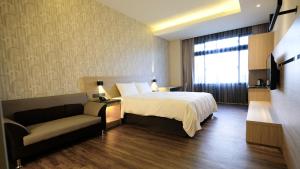 Postel nebo postele na pokoji v ubytování Yu Chun Hotel