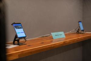a wooden counter with a tablet computer on it at Blue Cove Terrace in Miyako Island