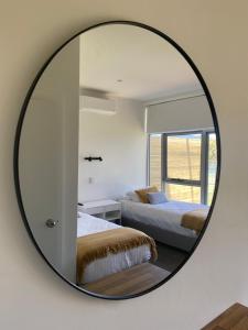 a living room with a large mirror on the wall at Orford Blue Waters Hotel in Orford