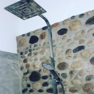 a street light in front of a stone wall at Ella Secret Paradise in Ella