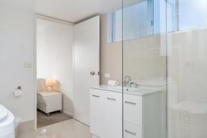 a white bathroom with a sink and a shower at Eden Tower in Gold Coast +116 photos