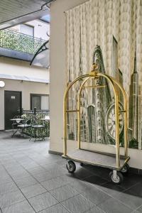a gold cage in front of a wall with a building at Airport Hotel Sydney (Formerly Comfort Hotel Sydney Airport) in Sydney