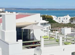 a white house with a view of the ocean at Langebaan Paradise Beach Self Catering 5 Elara in Langebaan