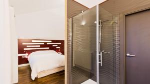 a bedroom with a bed and a glass shower at Hotel Las Casas de Pandreula in Berlanga de Duero