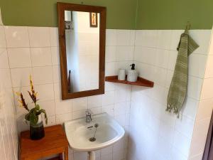 y baño con lavabo y espejo. en Utamaduni House B&B en Arusha
