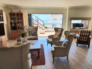 a living room with chairs and a table at Langebaan Paradise Beach Self Catering 4 Elara in Langebaan