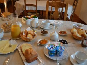 una mesa con comida para el desayuno y bebidas en ella en Les Célestines, en Lavannes