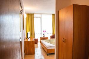 a room with a bedroom with a bed and a window at Hotel Mures in Saturn