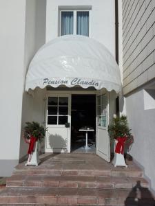 an entrance to a building with a white awning at Pension Claudia in Vösendorf