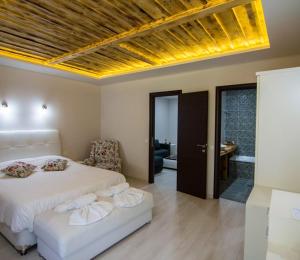 a bedroom with a bed and a couch in it at Archontiko Liamas in Stavros