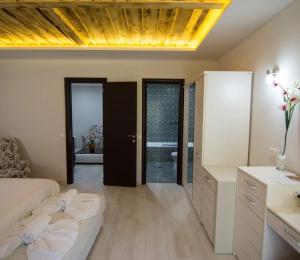 a bedroom with a bed and a bathroom with a tub at Archontiko Liamas in Stavros