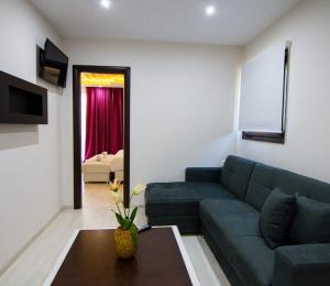 a living room with a blue couch and a table at Archontiko Liamas in Stavros