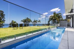 a swimming pool in a house with a view of the ocean at Lakes Resort in Toukley