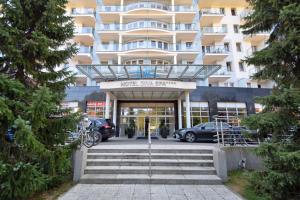 a building with cars parked in front of it at Apartament Prywatny w Diva SPA in Kołobrzeg