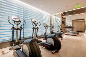 a gym with treadmills and ellipticals in a room at Shenzhen Ayearn Hotel in Shenzhen