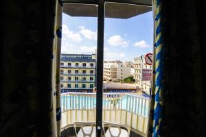 a view of a pool from a window at Topaz Hotel in St Paul's Bay