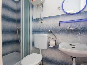 a bathroom with a toilet and a sink and a mirror at Apartments Tanfara in Brodarica +24 photos