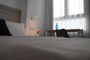 Postel nebo postele na pokoji v ubytování Hotel Sunna Benicassim